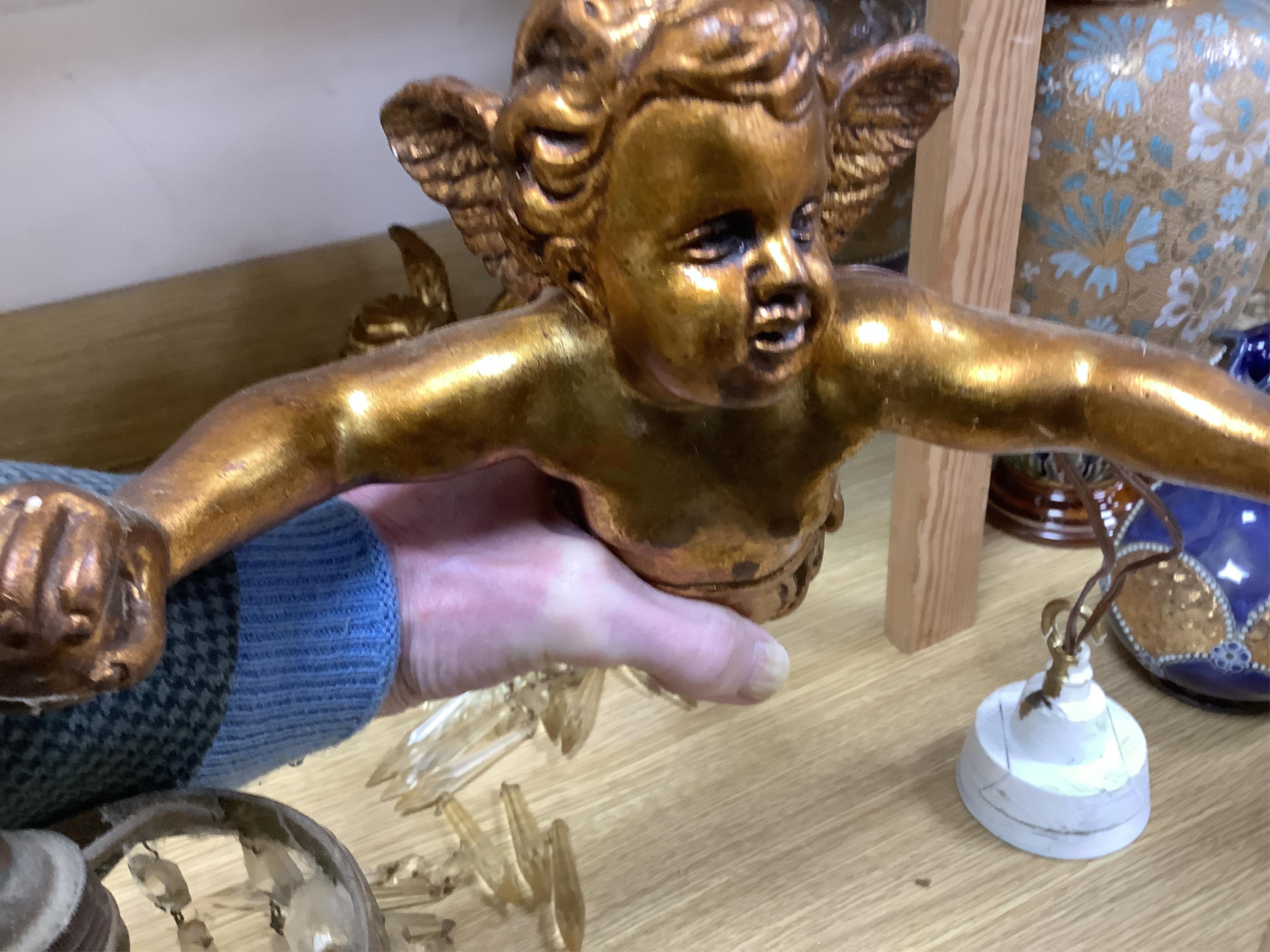 A pair of gilt twin branch cherub chandeliers with glass drops. Condition - some losses